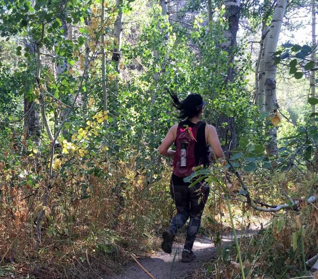 Woman trail running near Scott's Lake in Lake Tahoe