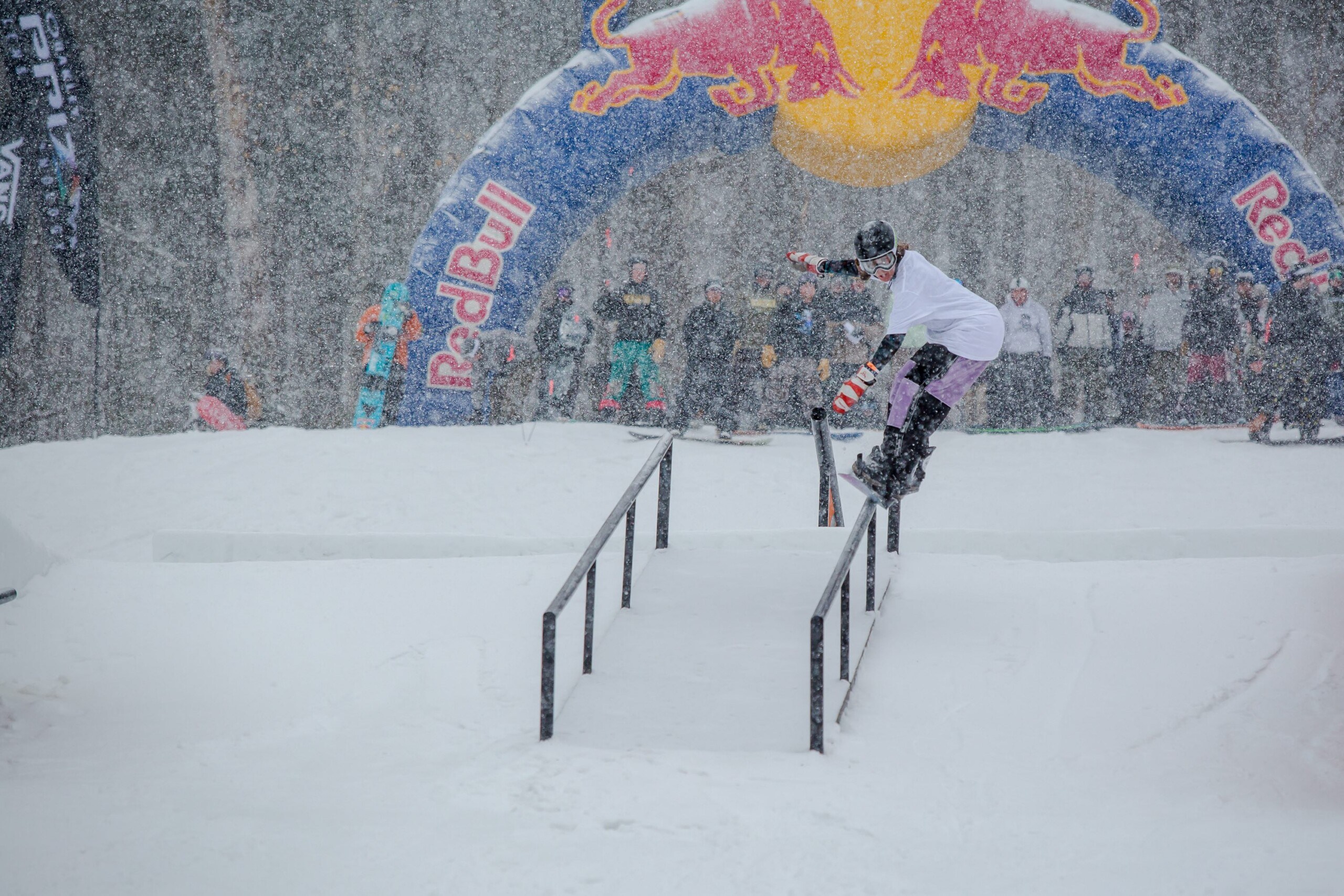 Snowboarder battling the weather and a hand rail at Eastern Boarders Last Call event