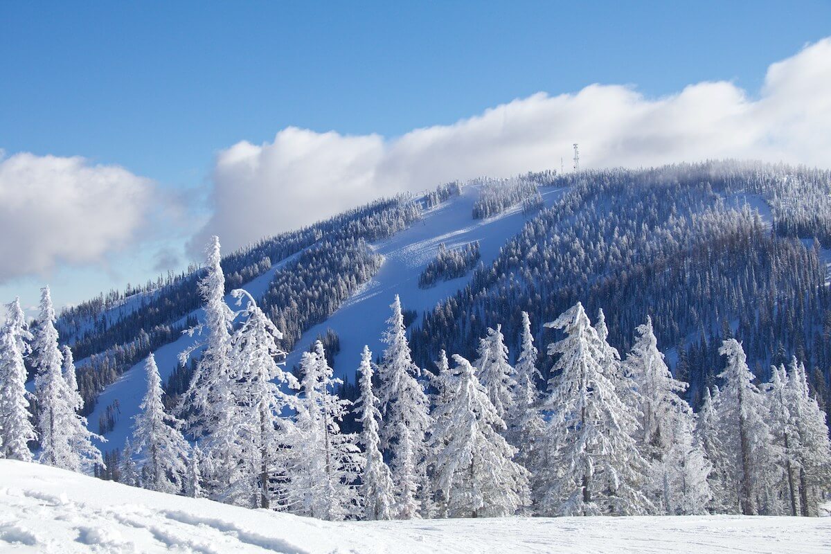 Sunny winter day at 49 North Ski Resort in Washington with ski trails in shade