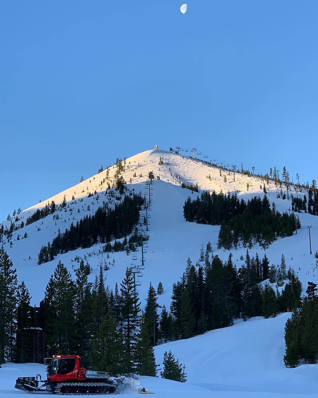 One of the cheap ski areas in the USA Hoodoo Ski area at dawn with a moon above it