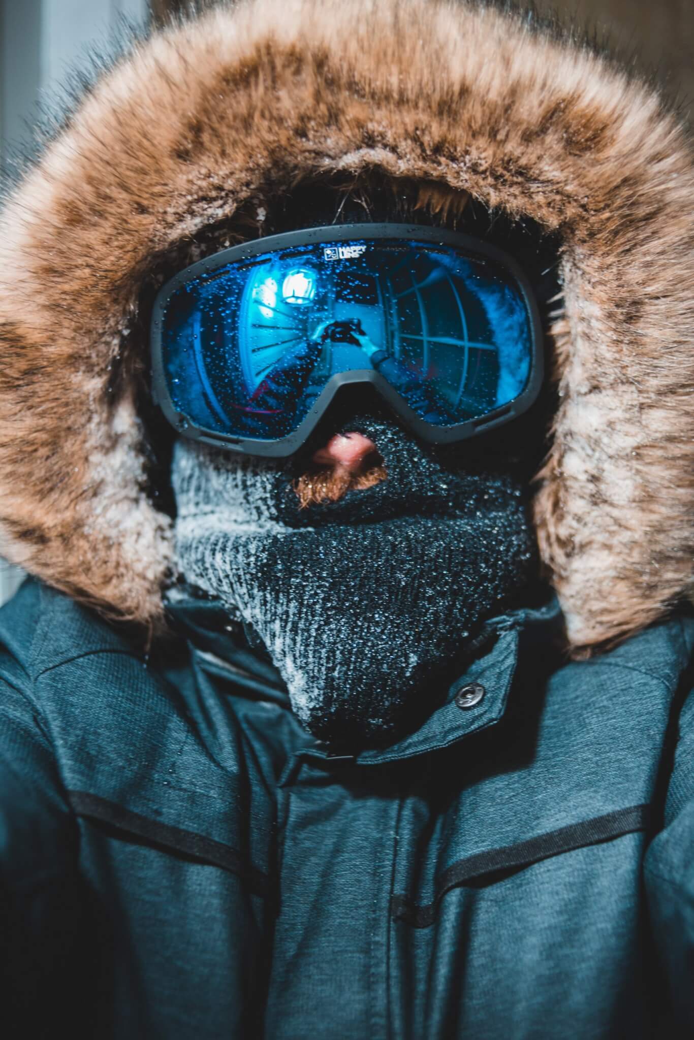 Spy Snowboard Goggles on Man in a winter coat