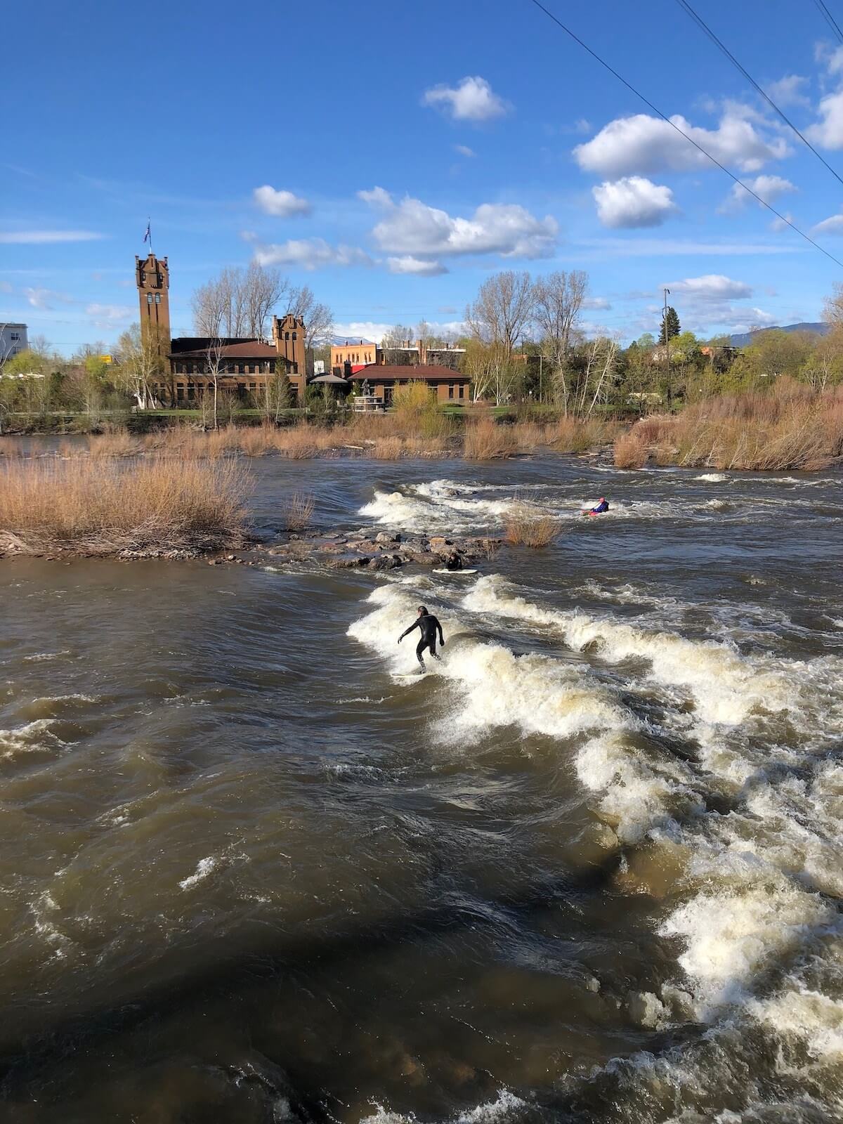 surfer river surfing on Brennan's Wave in Missoula Montana