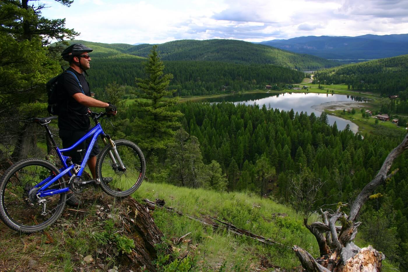 man overlooking view on mountain biking trail Whitefish Montana