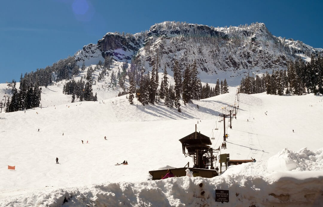 Best ski area for La Nina winter chairlift with mountain behind it