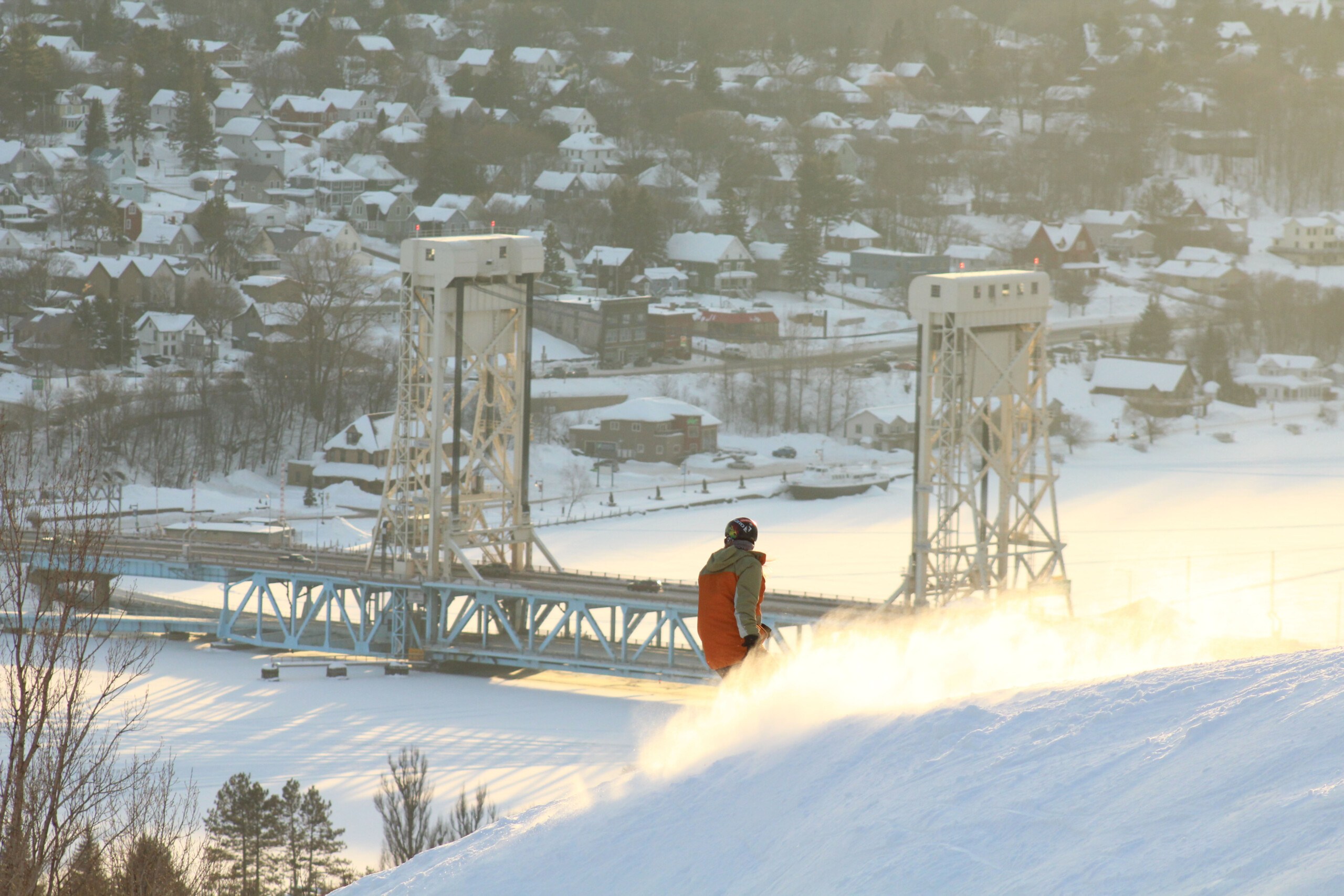 snowboarder enjoying powder at dawn at Mont Ripley Ski Area