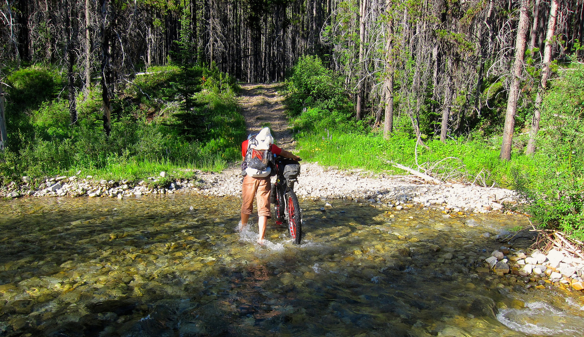 person fording a river on Tour The Divide