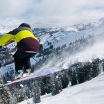 skier leaping at Kirkwood Ski Resort on a powder day