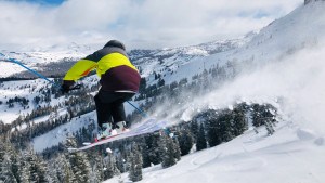 skier leaping at Kirkwood Ski Resort on a powder day
