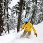 Snowboarder enjoying powder at Sierra-at-Tahoe