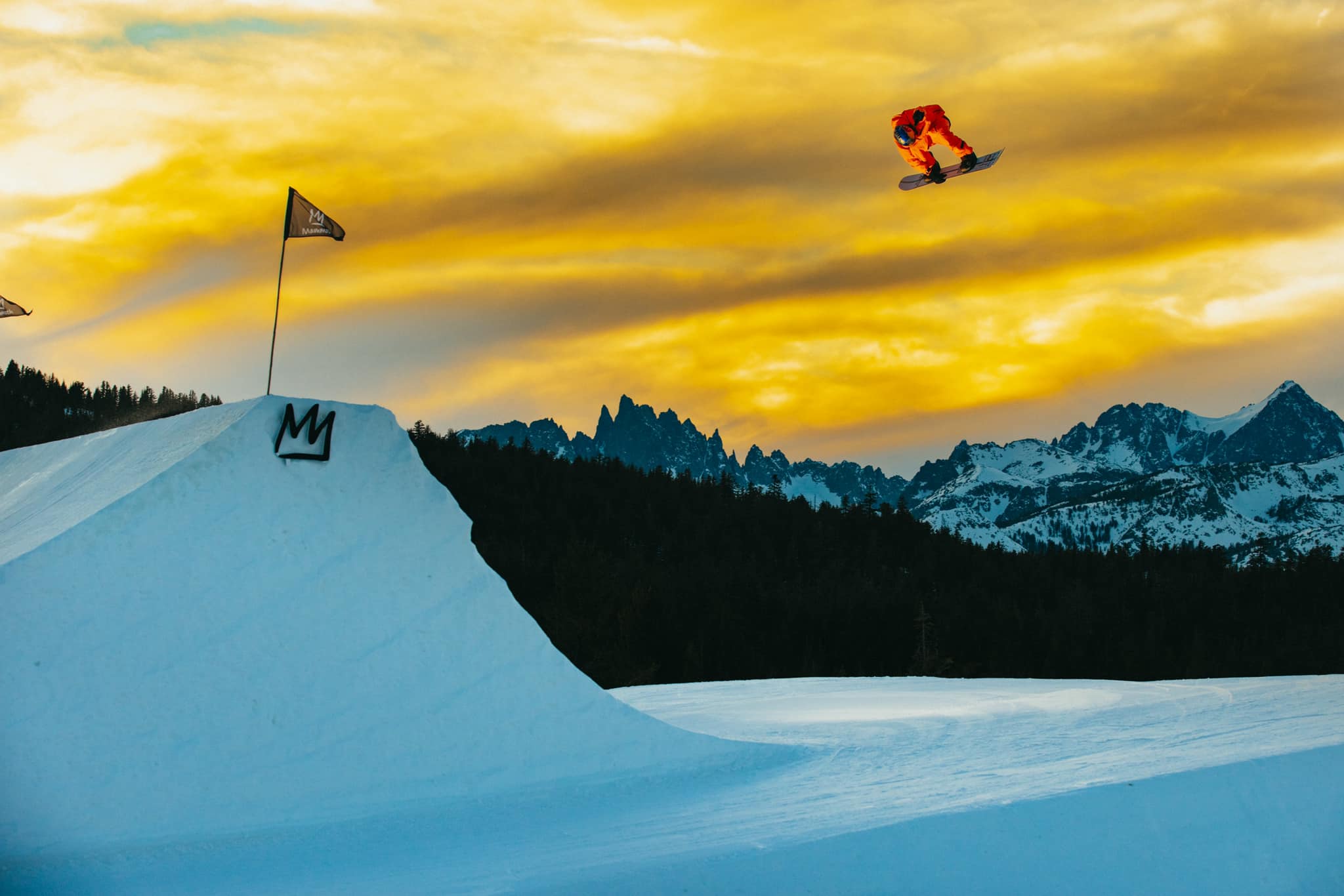 snowboarding doing a huge jump at Mammoth Mountain at dusk