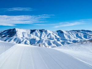 groomed corduroy-like snow at Soldier Mountain Ski Resort with the snow covered peaks of the Soldier Mountain range