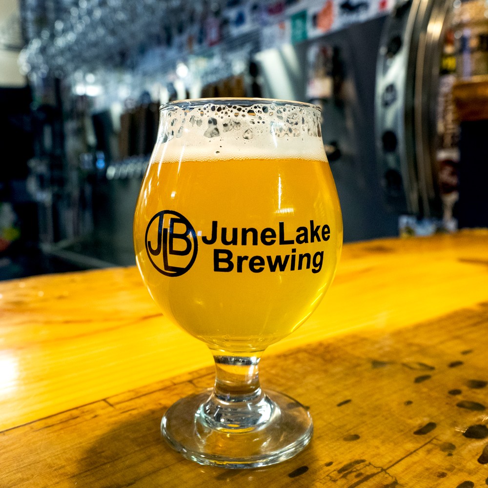 An amber colored ale in a small goblet inside June Lake Brewing