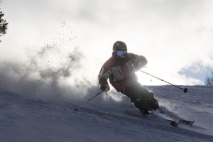 skier with mustache carving in powdery snow at Snowriver Mountain Resort