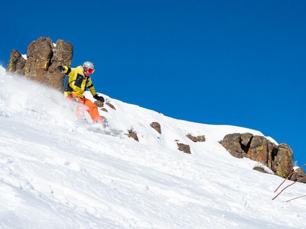 snowboarder making a powder turn at Magic Mountain Idaho