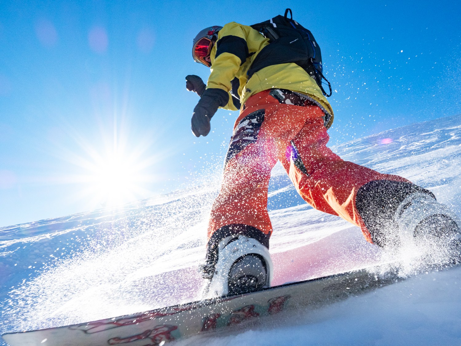 snowboarder carving powder at Magic Mountain Ski Resort in Idaho