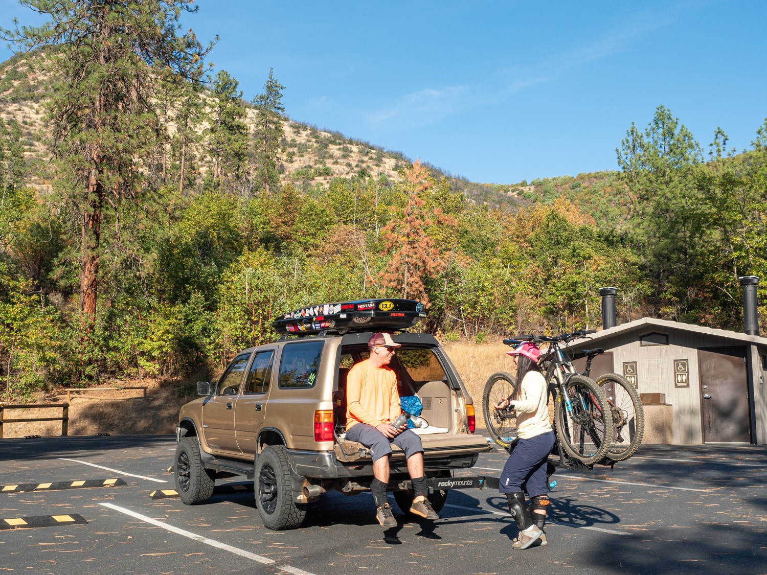 two mountain bikers at trailhead for Mountain of the Rogue trail system