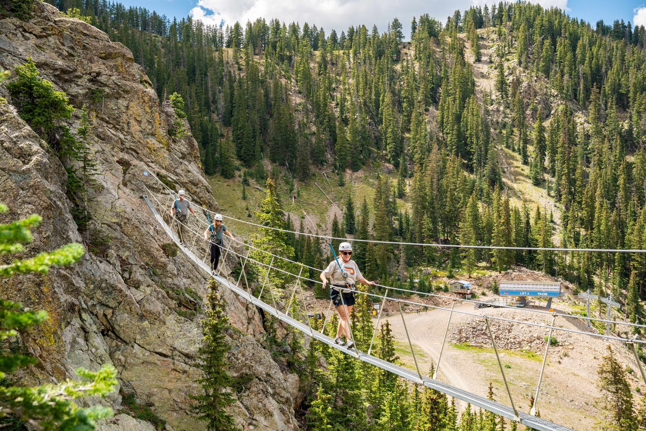 Taos Via Ferrata wire bridge with a lift in the background