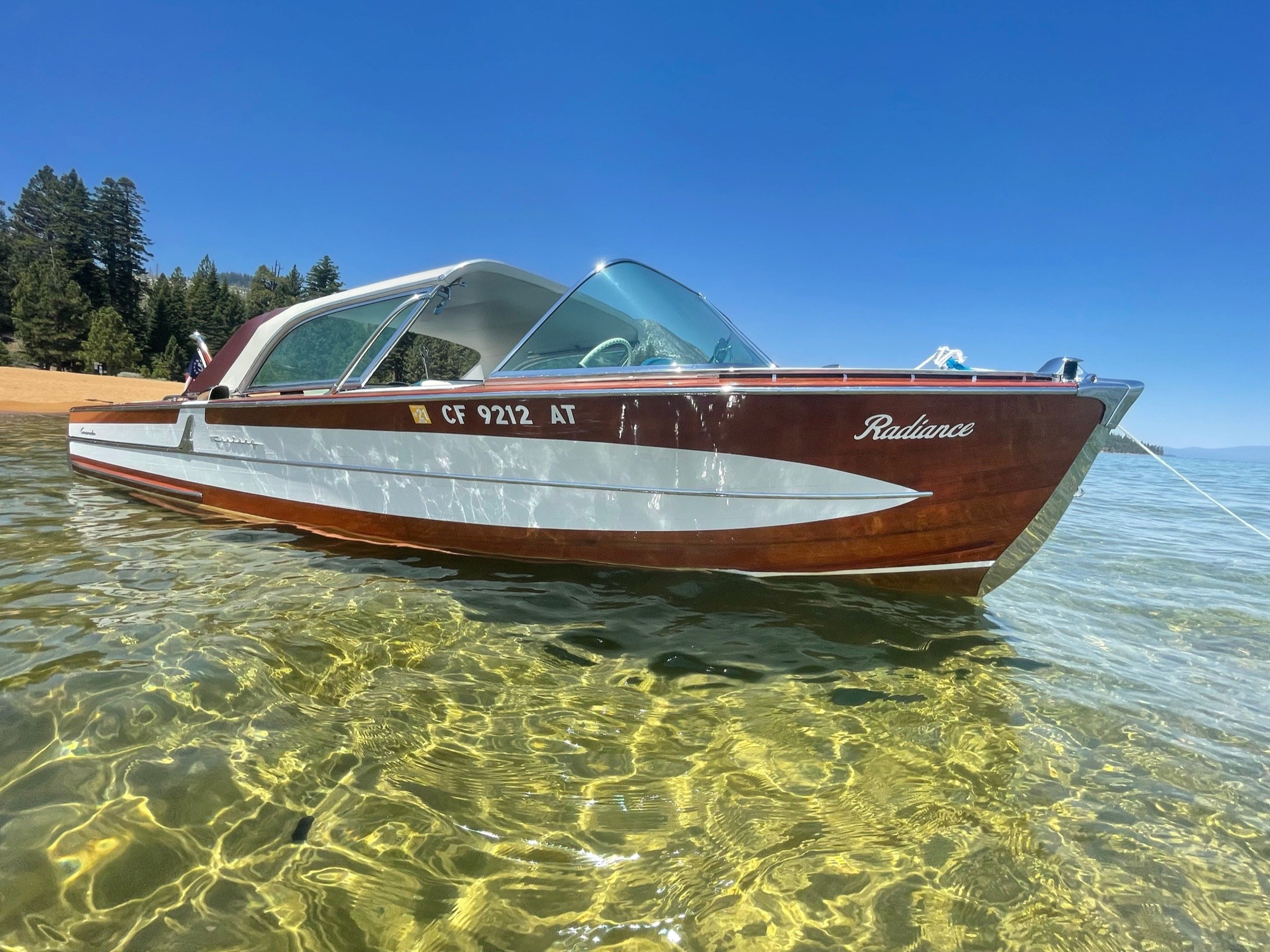 1958 Century Coronado a classic wooden boat on Lake Tahoe parked on a beach