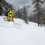 Snowboarder enjoying fresh powder on Eagle Peak at Lookout Pass Ski Area near Wallace Idaho