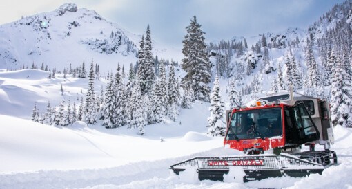 White Grizzly snow cat with Goat Range behind it