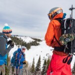 Skiers standing near the summit of Pike Mountain