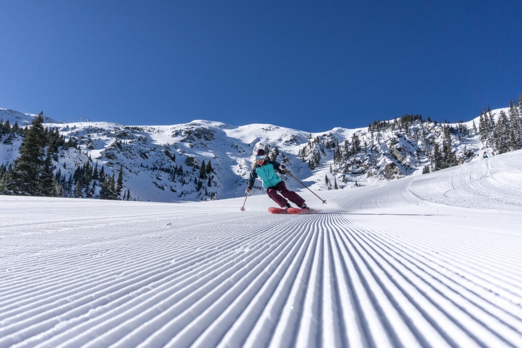 skier carving soft corduroy at Taos Ski Valley