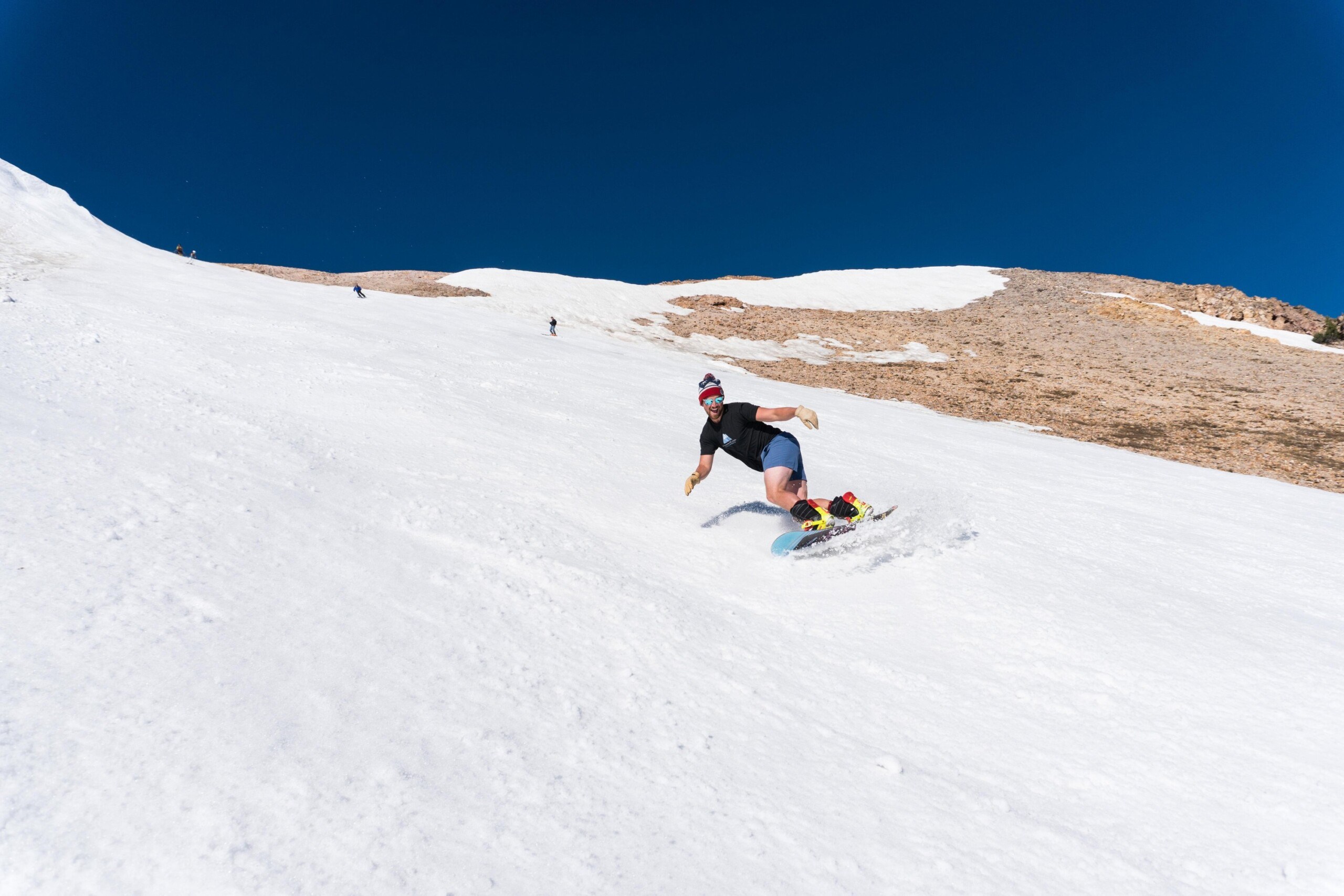 Snowboarder enjoying skiing in June at Mammoth Mountain