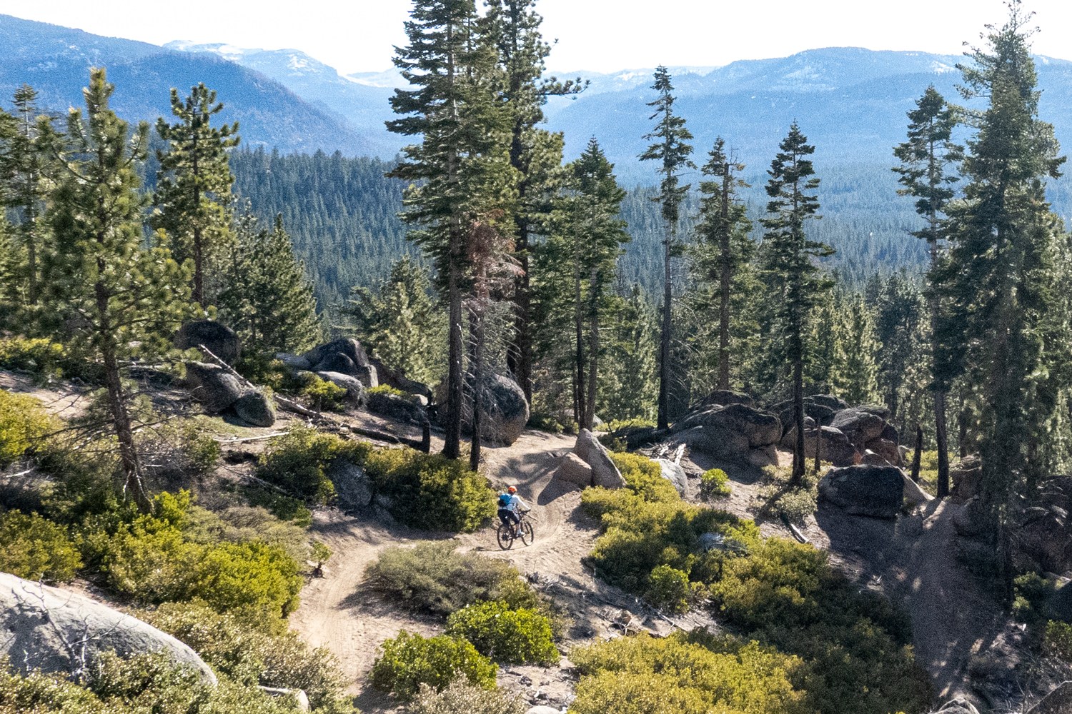 mountain biker going down Tahoe Mountain South Trail in late season