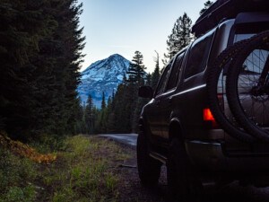 2nd Gen Toyota 4Runner with Mt Hood in the background holding two mountain bikes near 44 Trails