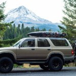 2nd Gen Toyota 4Runner with Mt Hood in the background holding two mountain bikes near 44 Trails