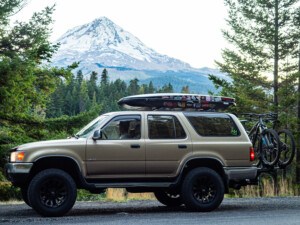 2nd Gen Toyota 4Runner with Mt Hood in the background holding two mountain bikes near 44 Trails