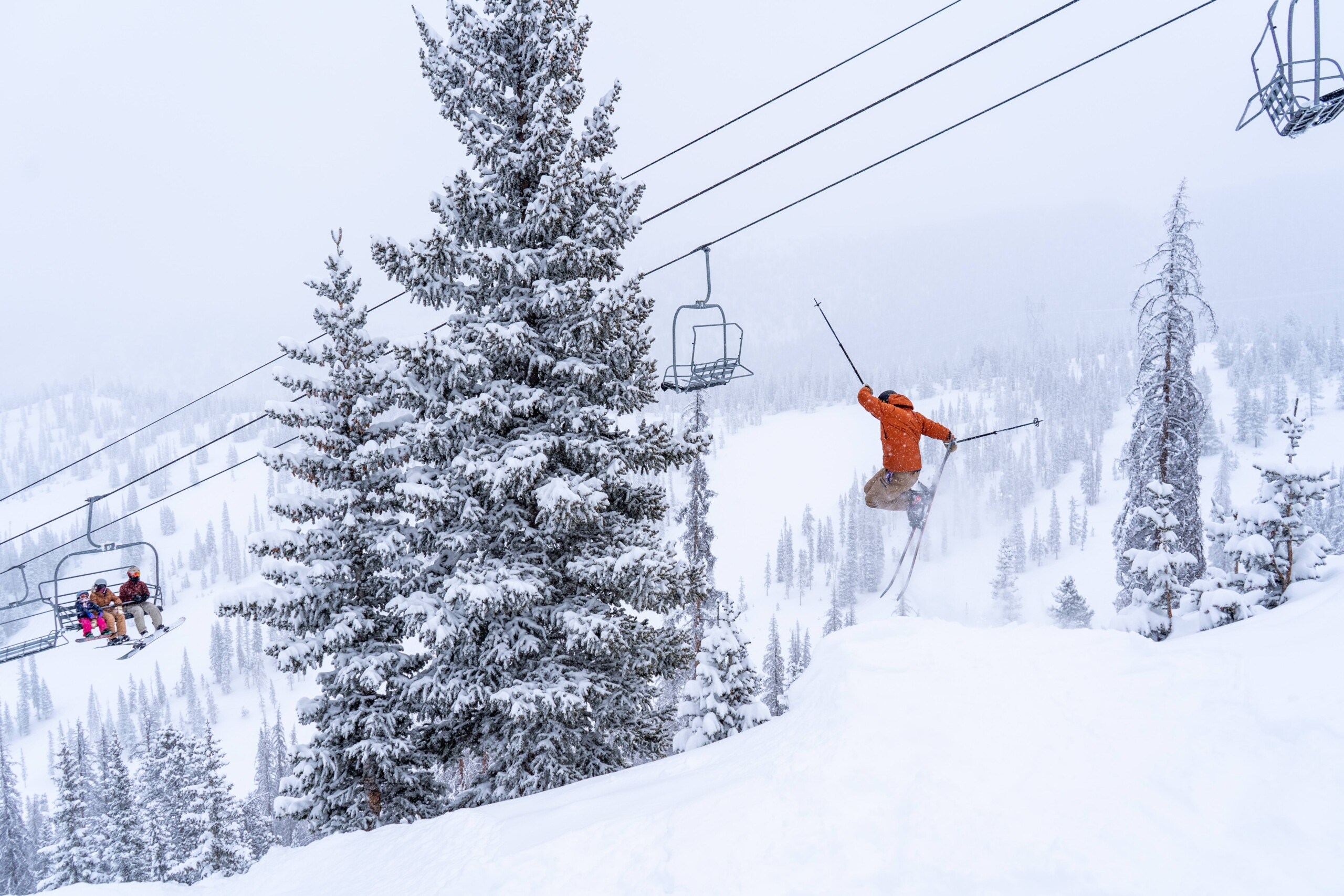 skier leaping into powder at Monarch Mountain