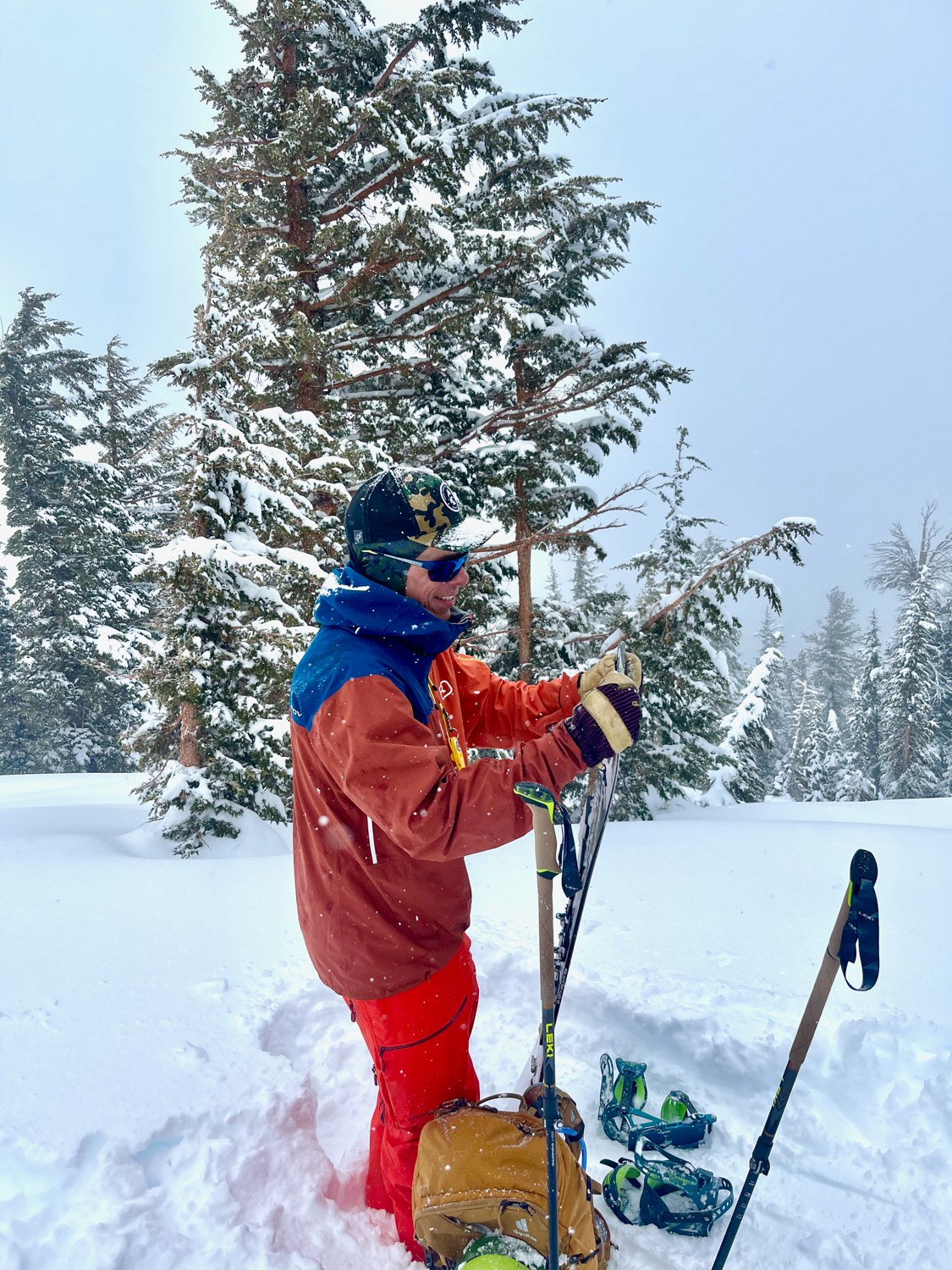 Splitboarder wearing the Norrona Lofoten tall snow pants with Ortovox jacket in the Tahoe backcountry during a storm