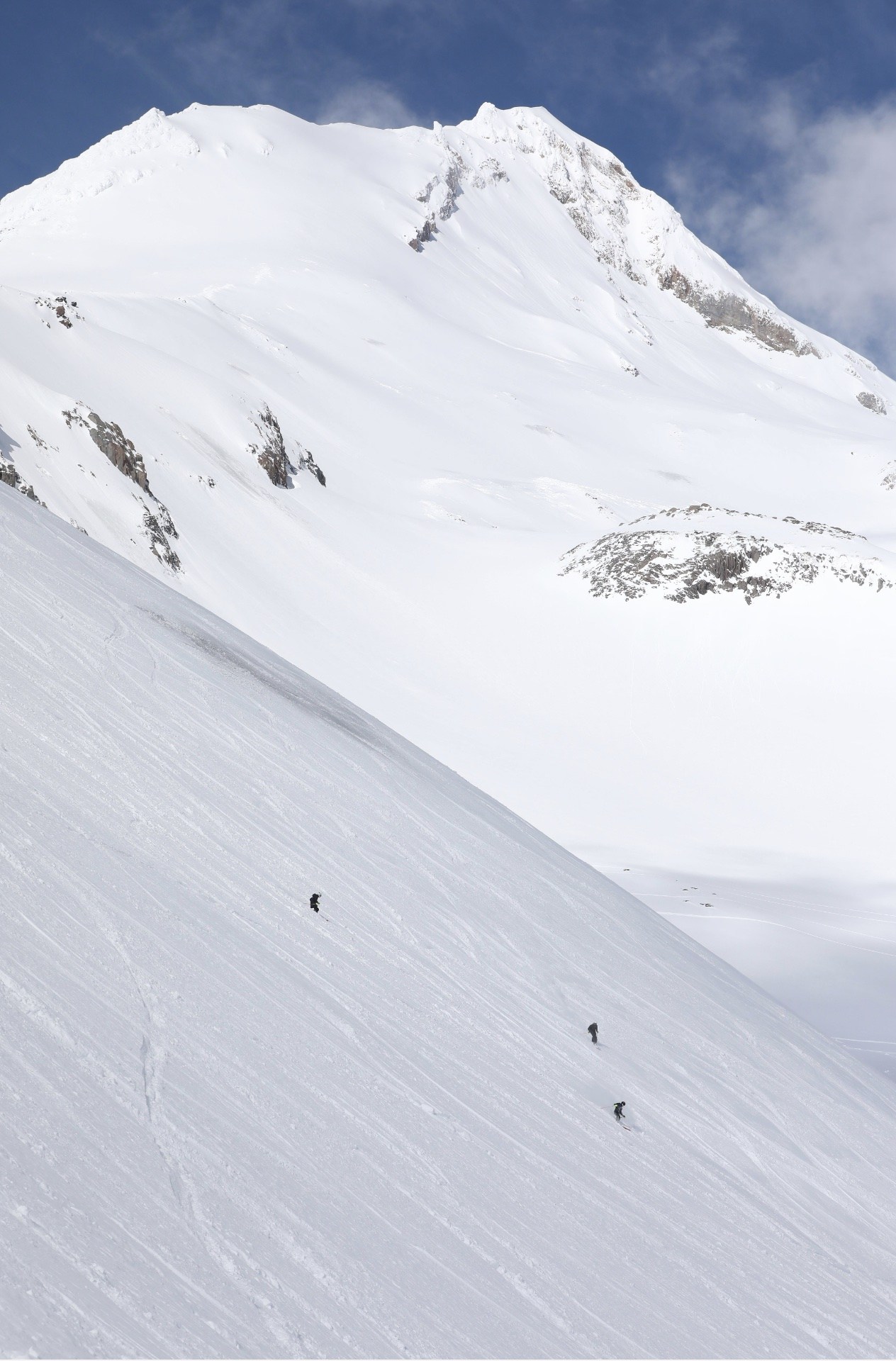 3 skiers riding down a steep slope in Heather Canyon at Mt Hood Meadows