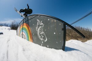 Snowboarder enjoying rainbow rail at Boyne Mountain