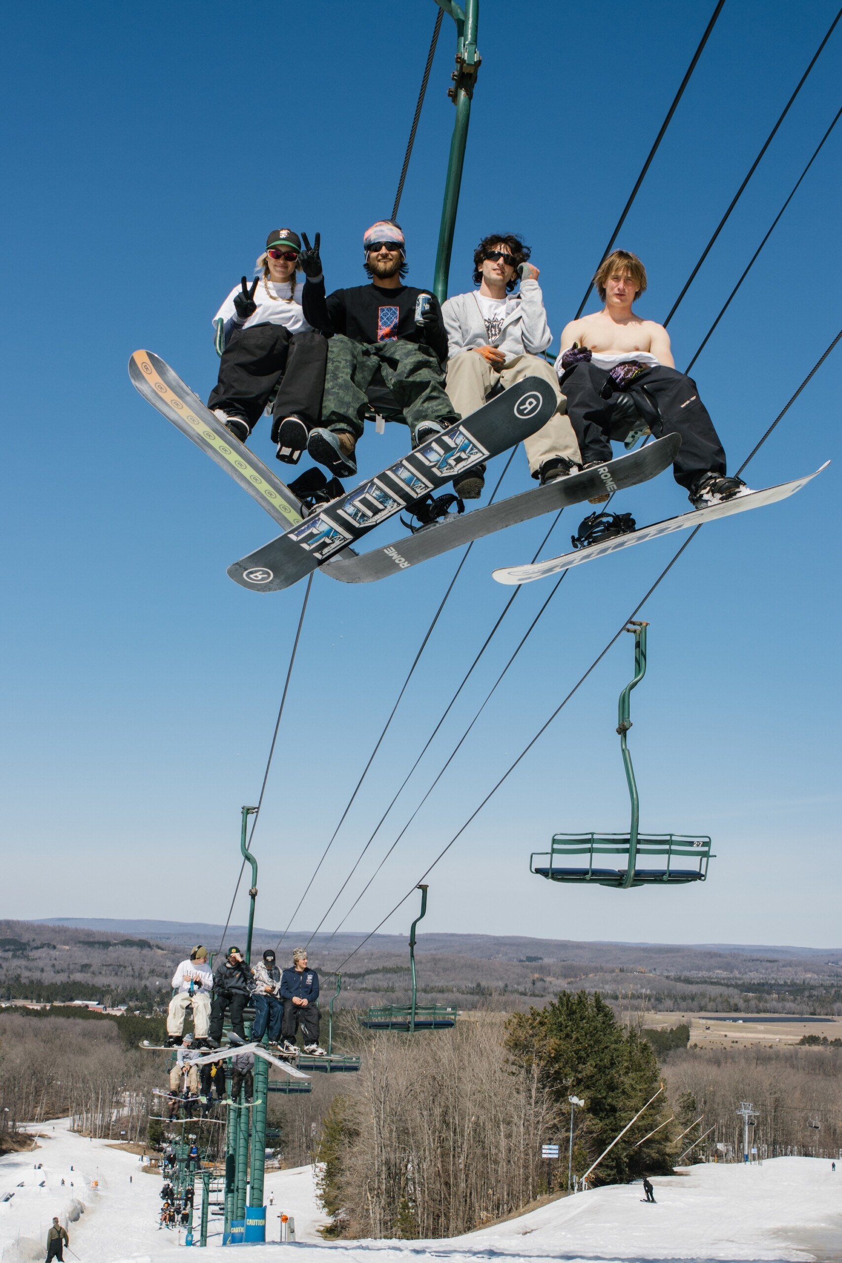 Snowboarders enjoying the lift ride up