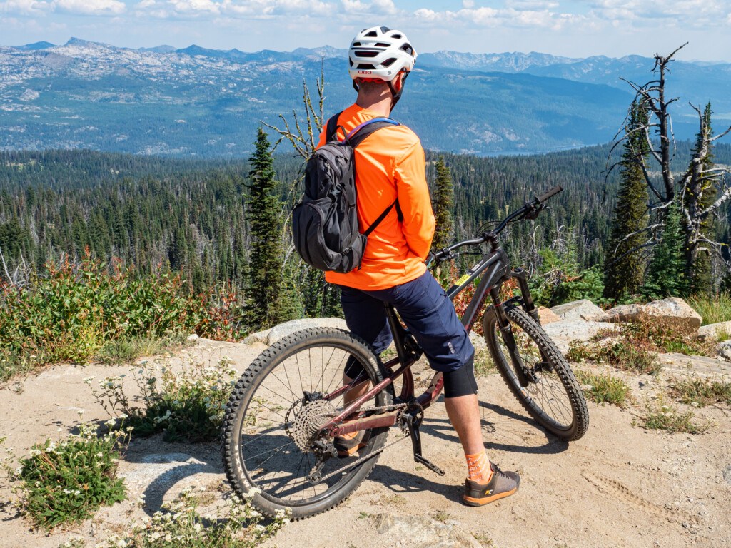 mountain biker overlooking the backcountry from the summit of Brundage Mountain