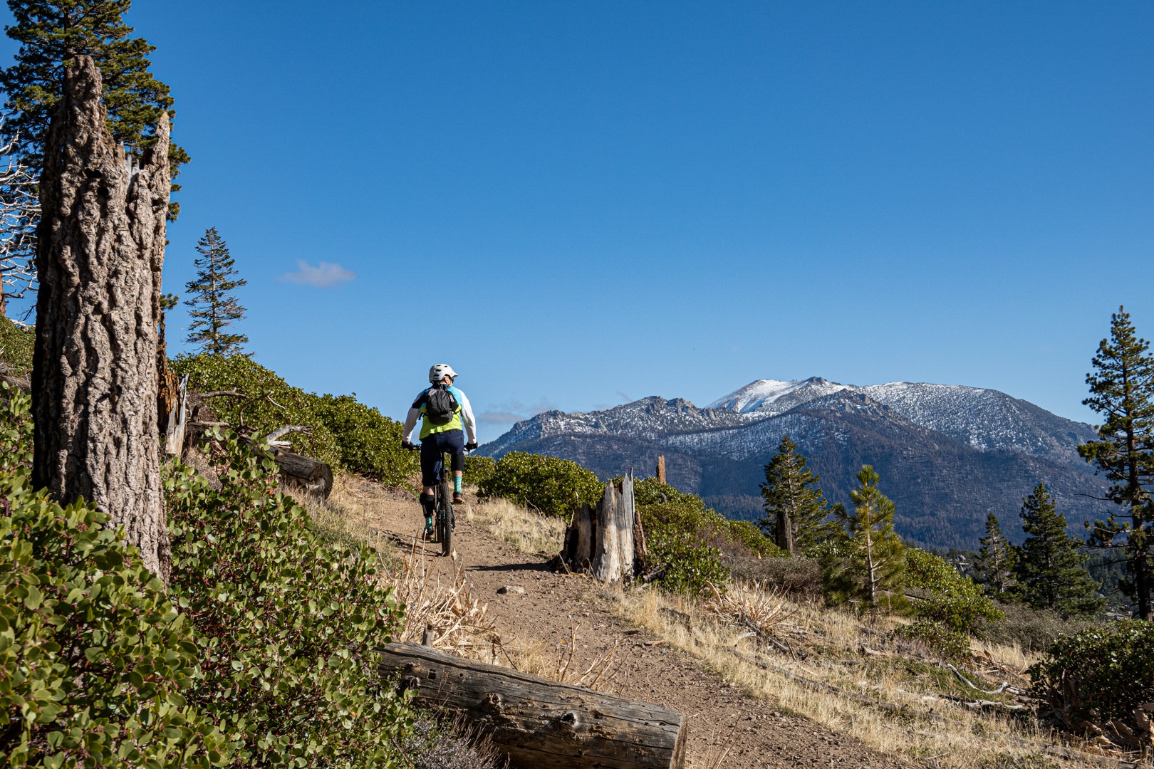 mountain biker pedaling up Tahoe Mountain South trail in winter