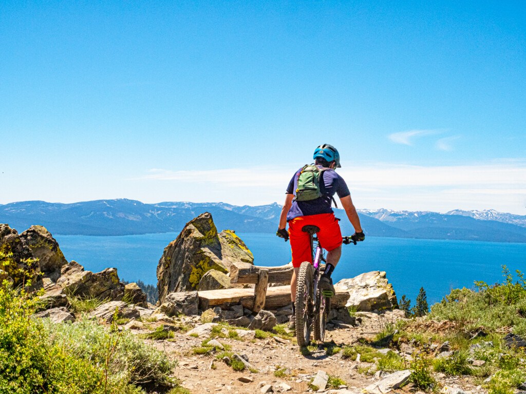 mountain biker overlooking Lake Tahoe on the Kingsbury section
