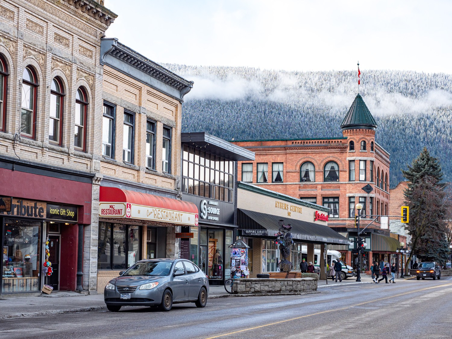 The town of Nelson on the Powder Highway with a coat of snow on the mountains above town