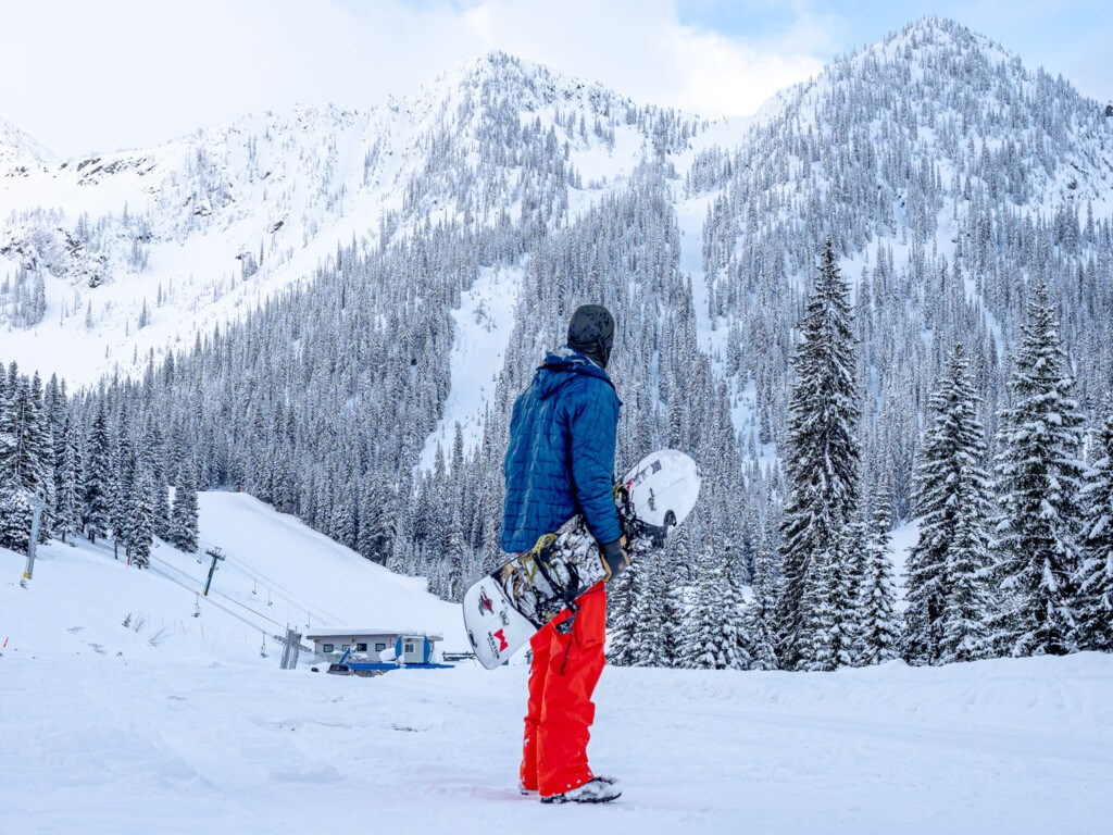 Snowboarder looking at the steep terrain at Whitewater Ski Resort