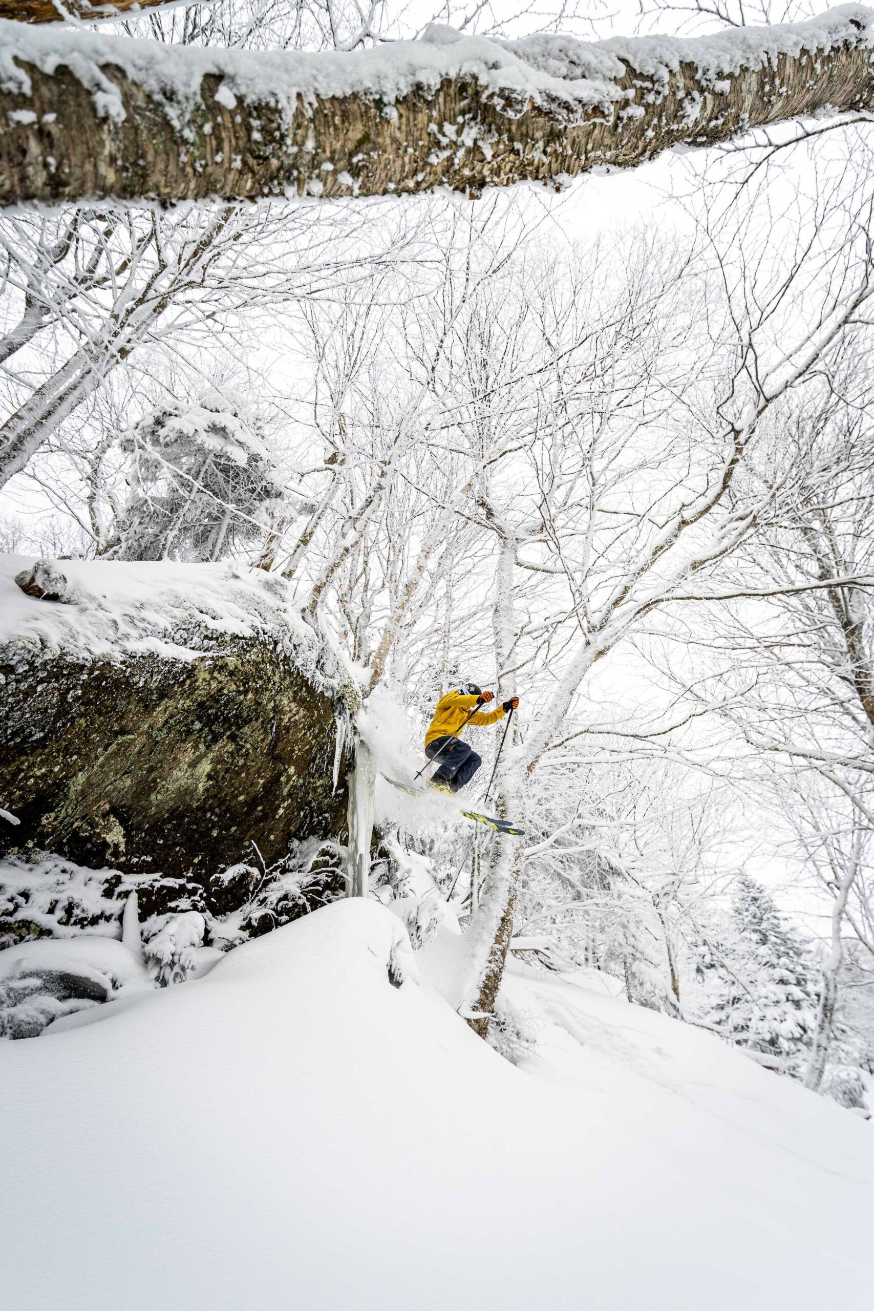 Skier jumping off cliff at Jay Peak