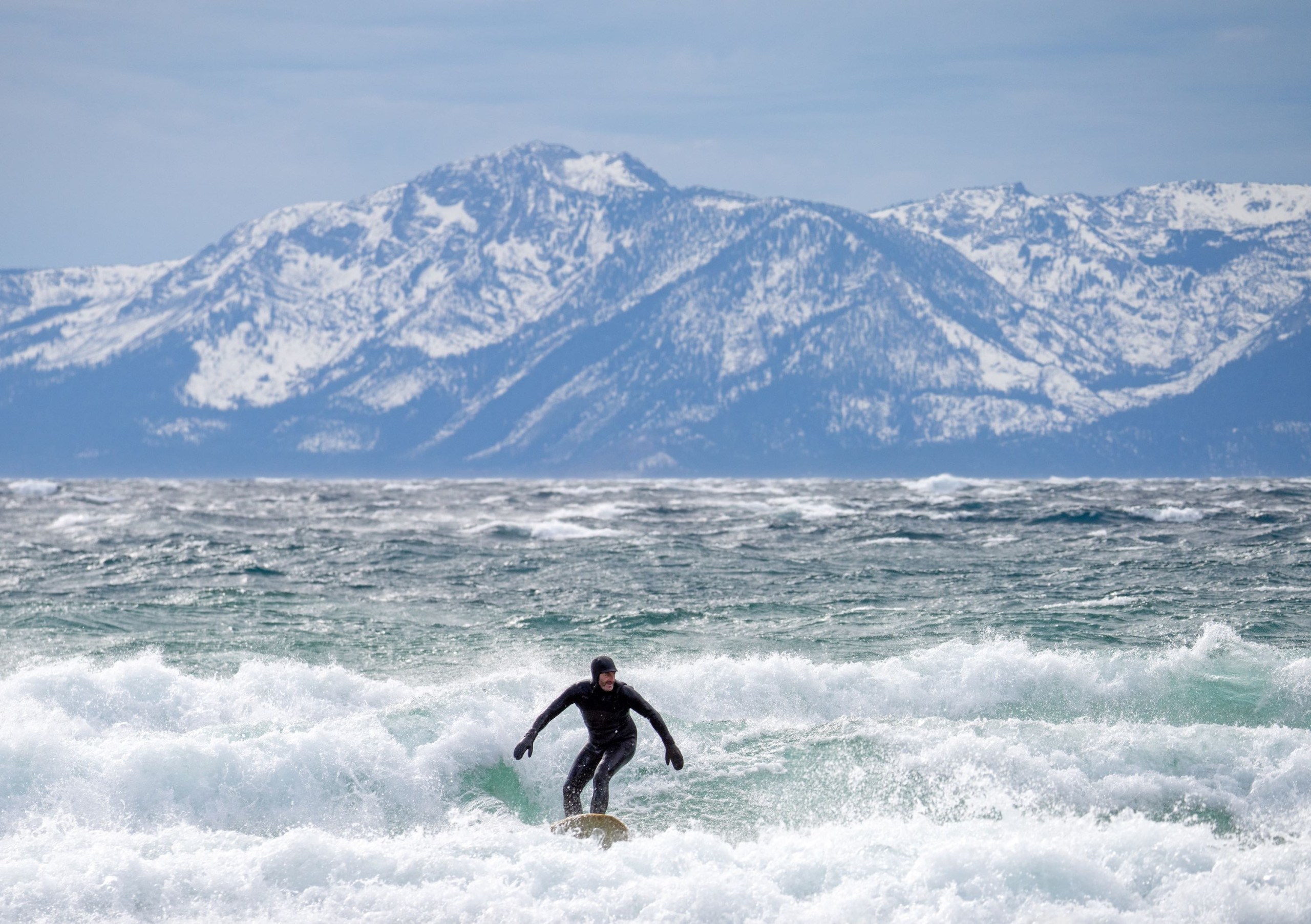 person surfing on Lake Tahoe early spring