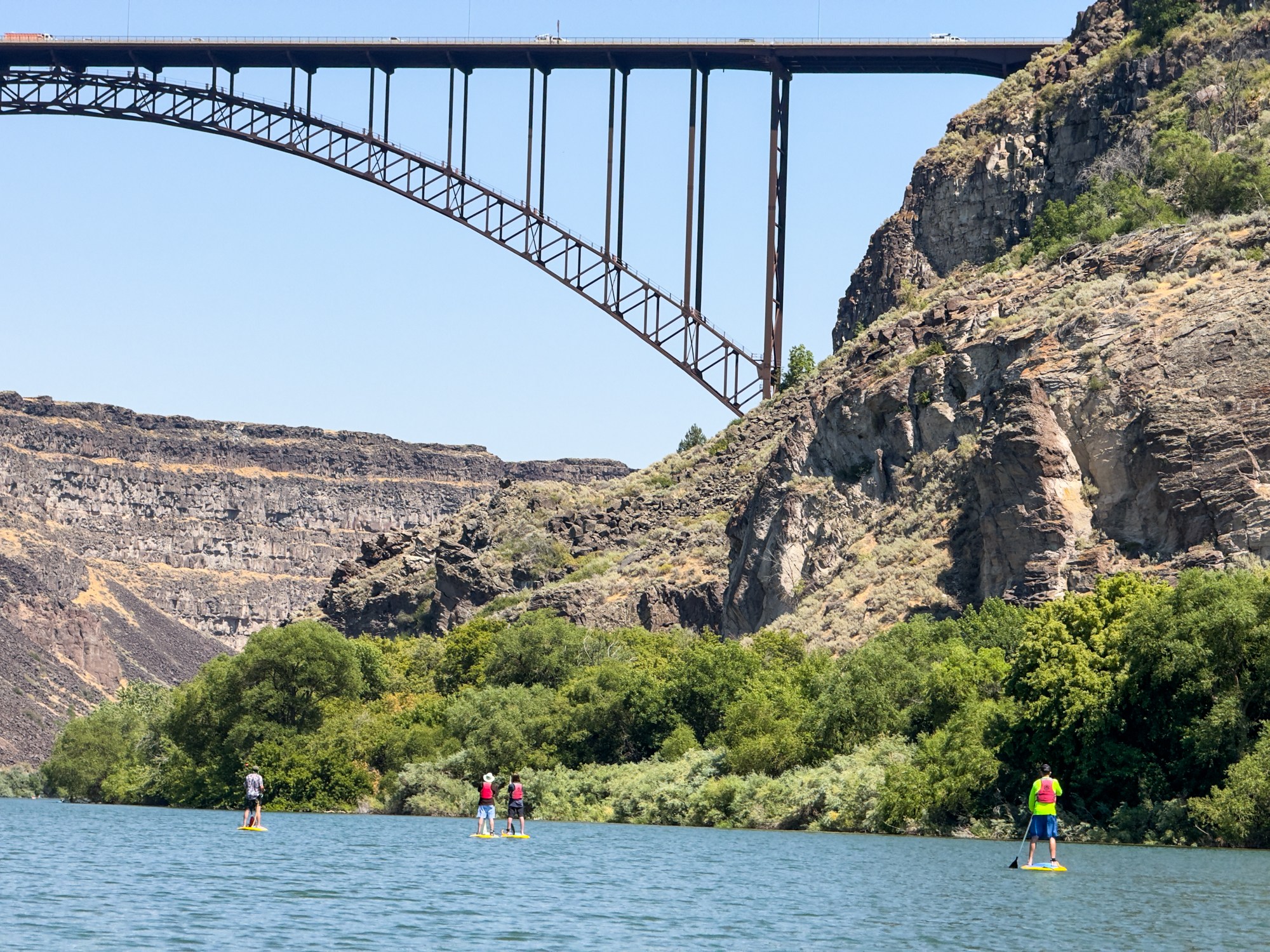 Standup paddleboarding on the Snake River with the Perrine Bridge in the background