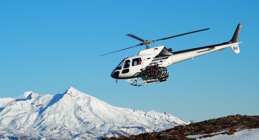 heli biking operation in New Zealand zipping across landscape with bikes on the helicopter