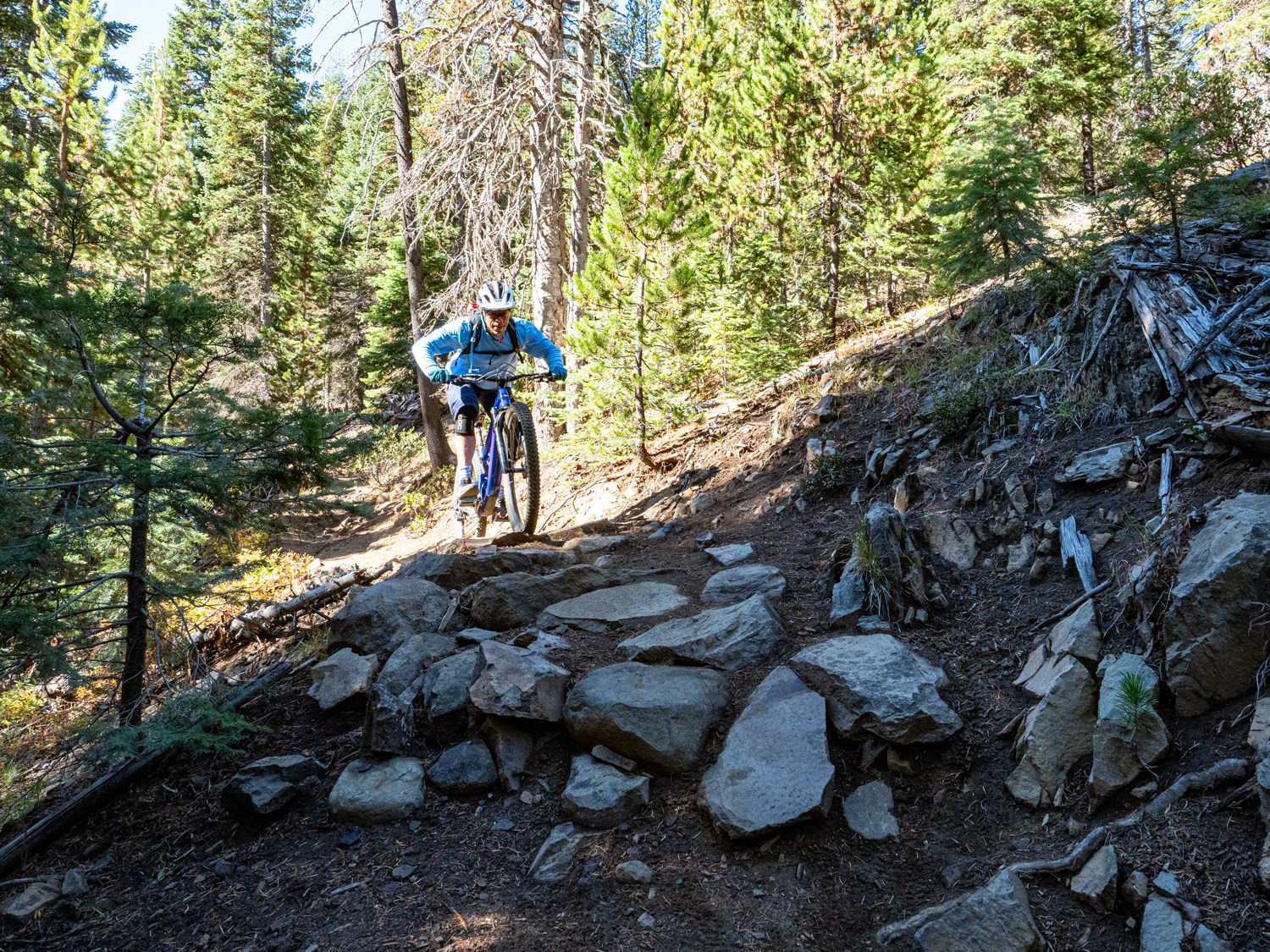 mountain biker navigating small rock garden on South Fork in Bend Oregon