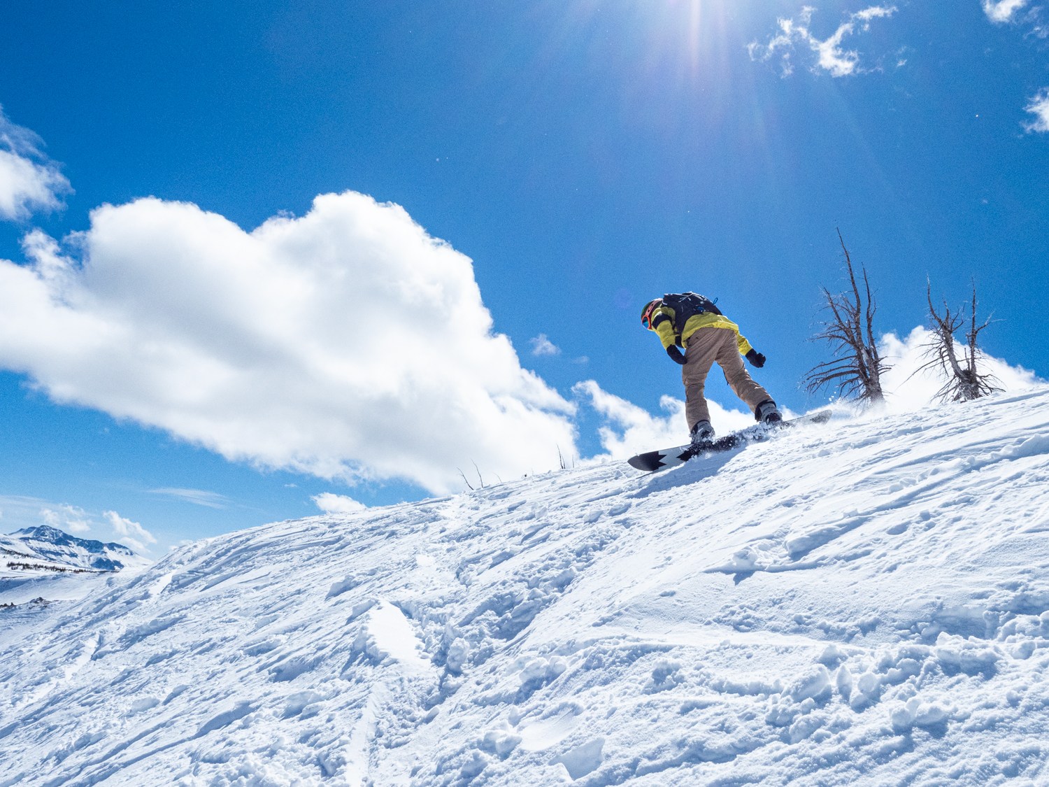 Snowboarder dropping the ridgeline at Wolf Creek Resort