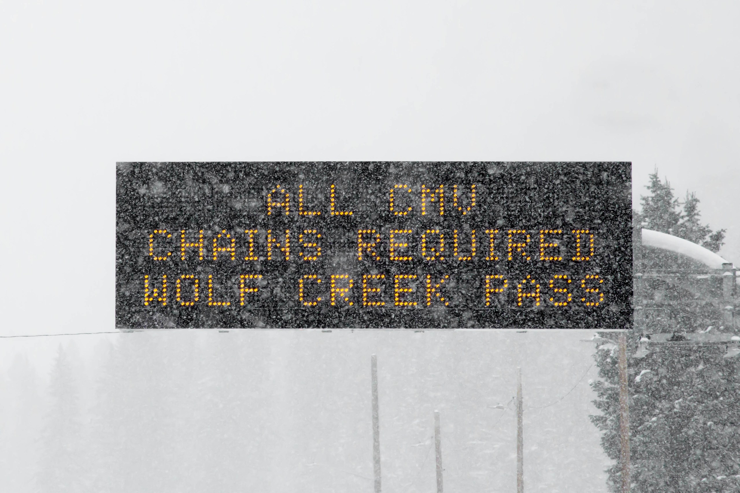 Chains required sign on Wolf Creek Pass during a winter storm