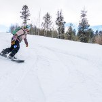 Jaime snowboarding in Outdoor Research Hemispheres bibs at Kelly Canyon