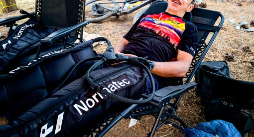 mountain biker enjoying PT Revolution's leg therapy after Rose to Toads